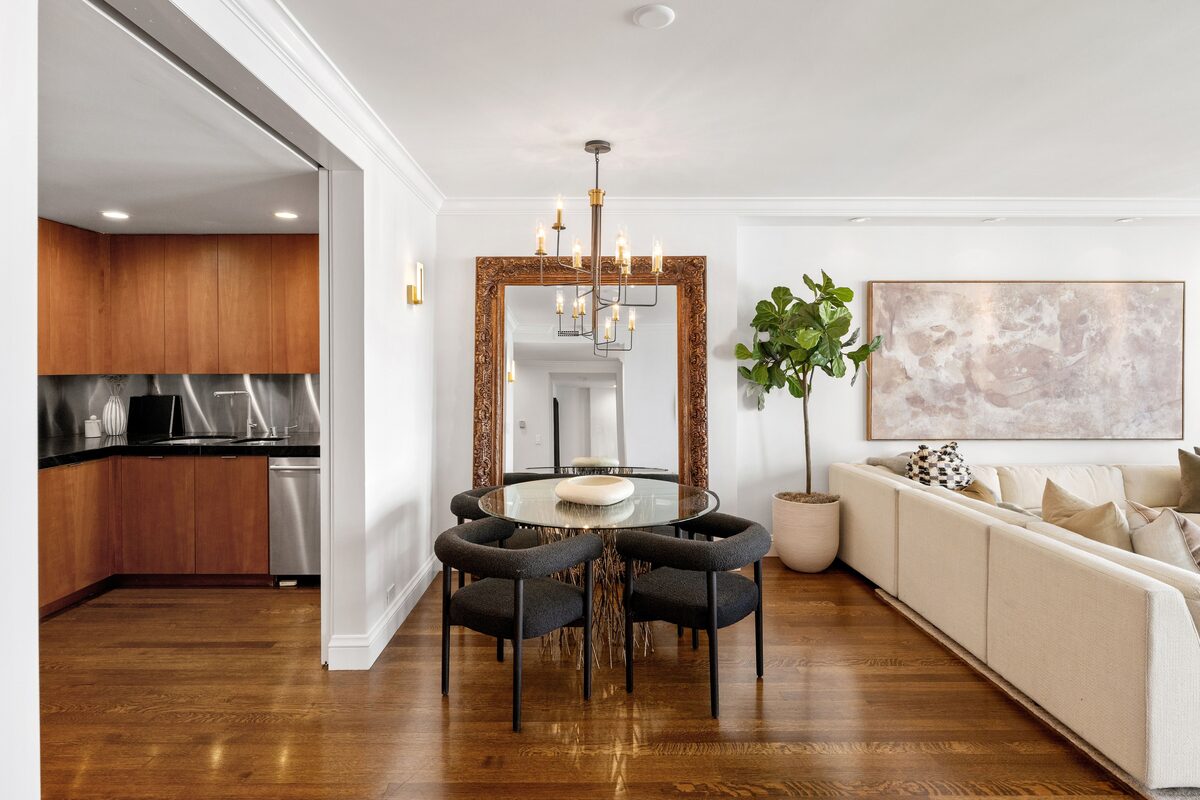 Dining area with ornate mirror and brass chandelier