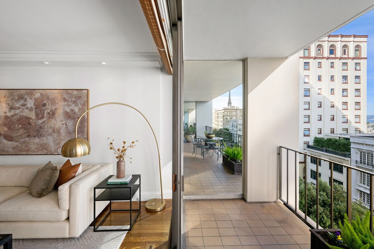 Living space looking out to private balcony with bay views