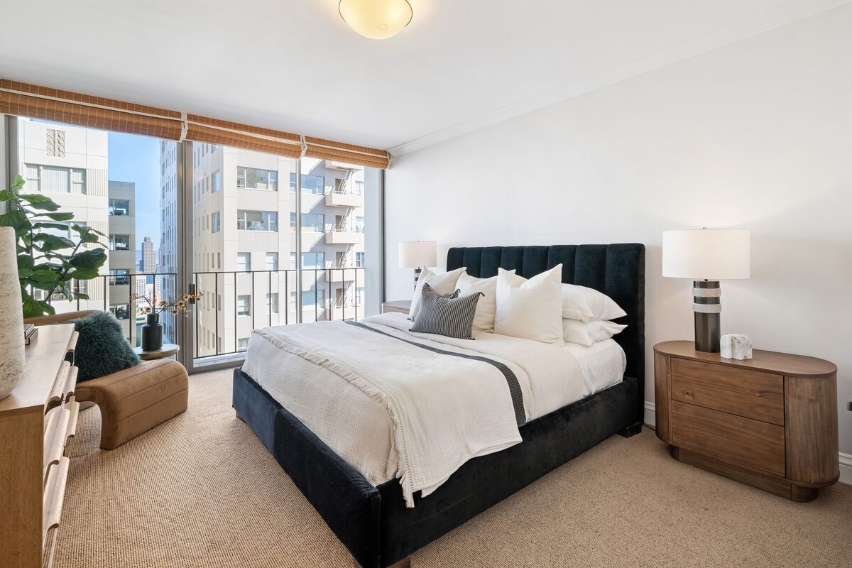Primary bedroom with city views and designer furnishings